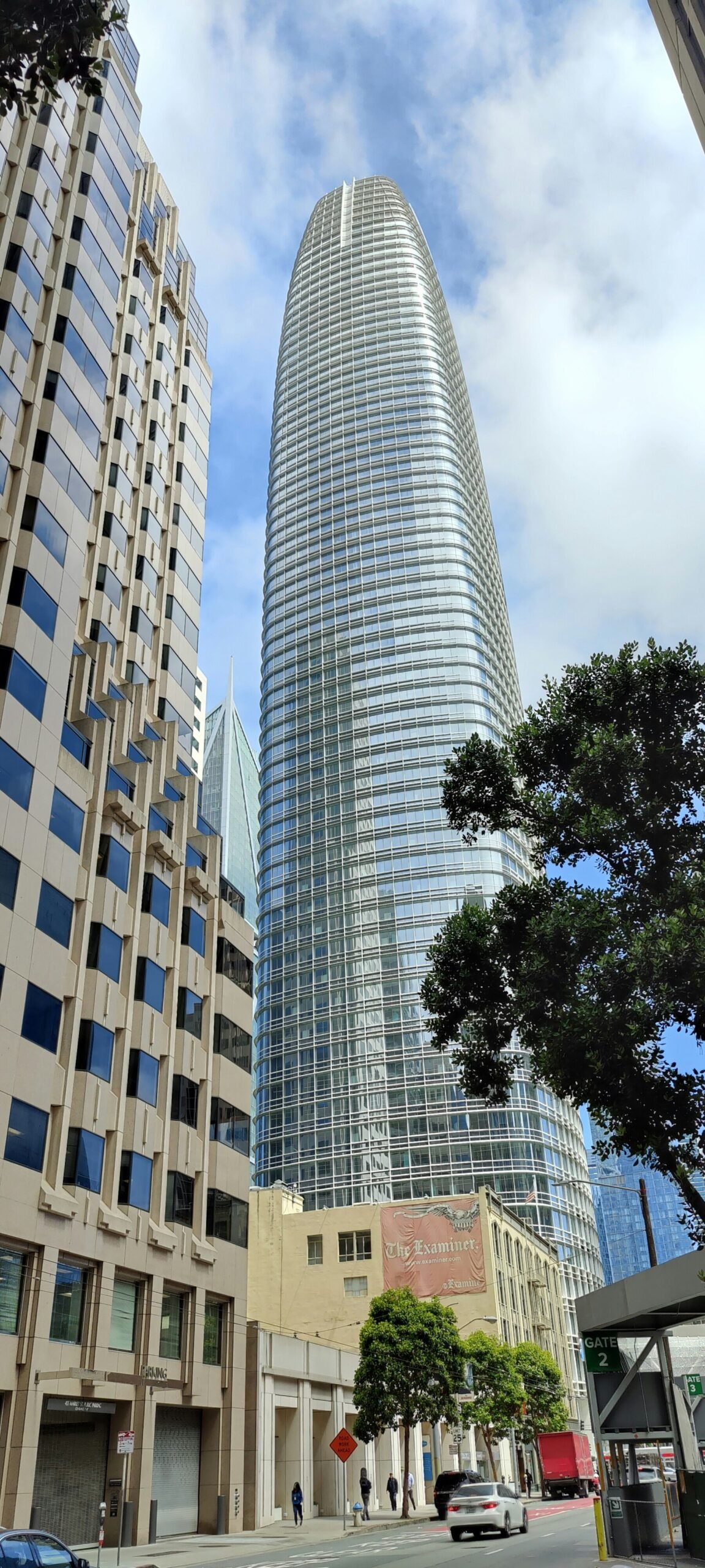 a city street with tall buildings in the background